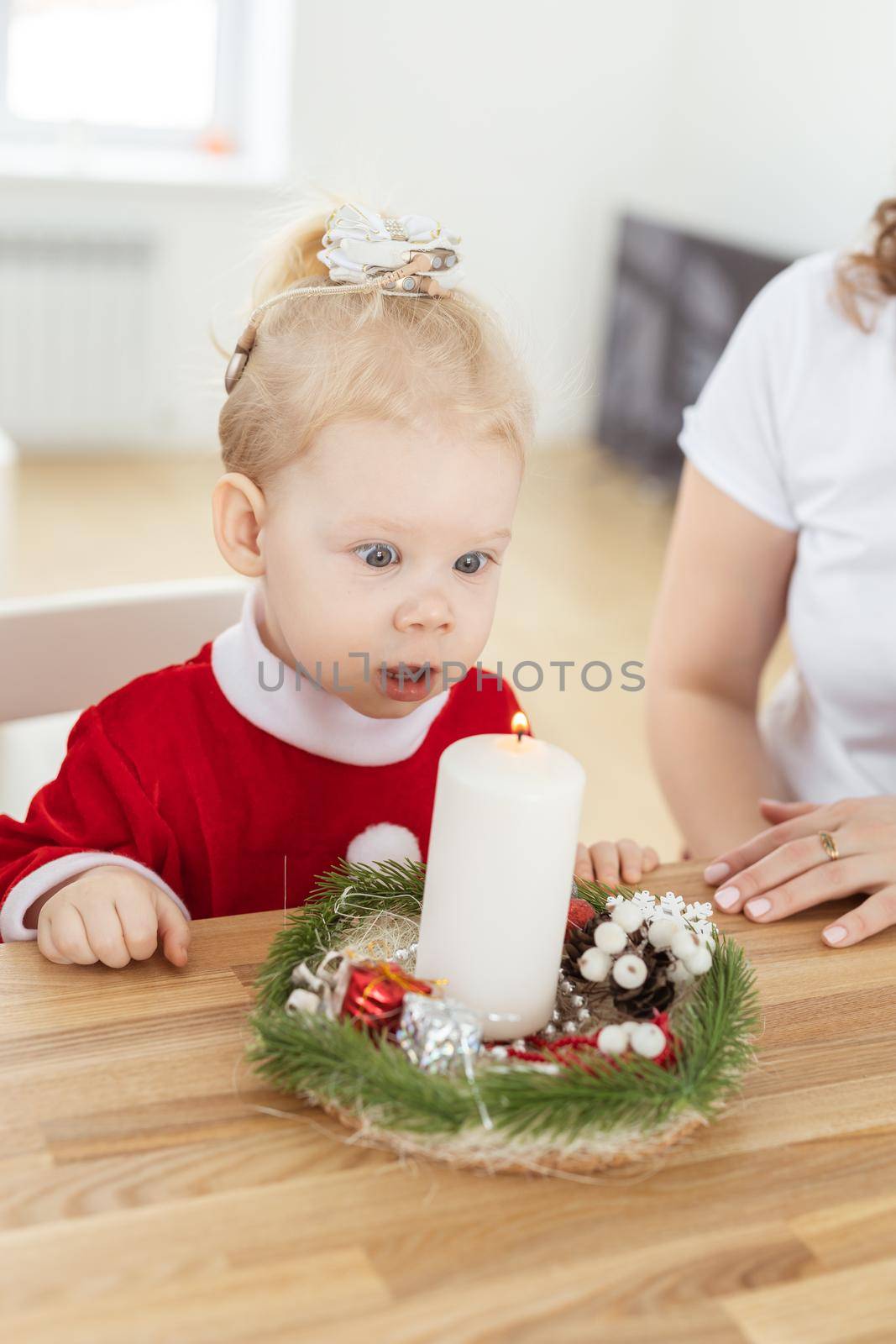 Baby child with hearing aid and cochlear implant having fun with parents in christmas room. Deaf , diversity and health concept by Satura86