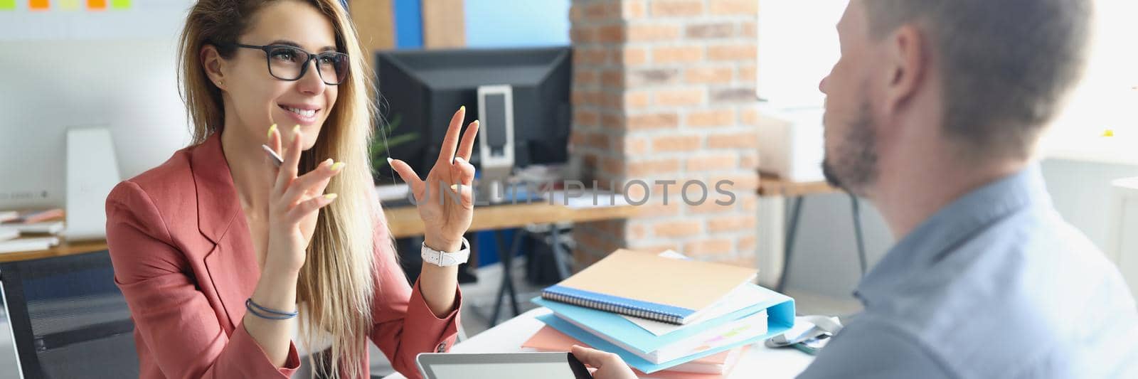 Portrait of workers meet in office to discuss working moments together. Woman in suit use gesture to explain idea to colleague. Business, creative concept