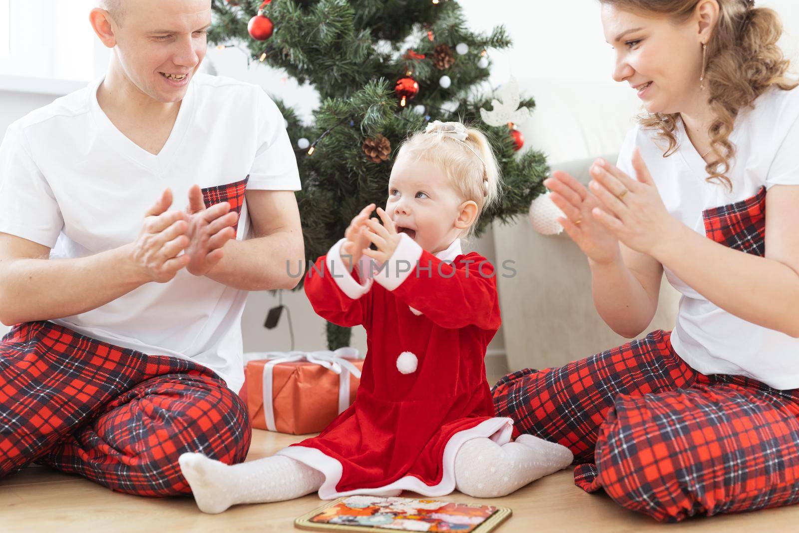 Toddler child with cochlear implant decorating christmas tree deafness and innovating medical technologies for hearing aid