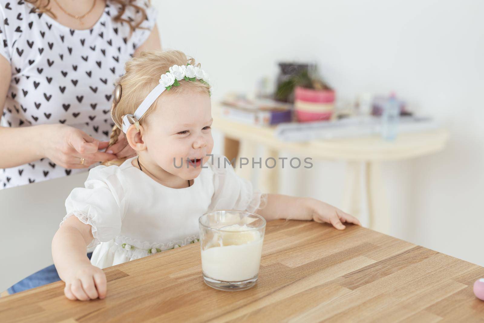 Cochlear implant on baby girl's head. Hearing aid and deafness