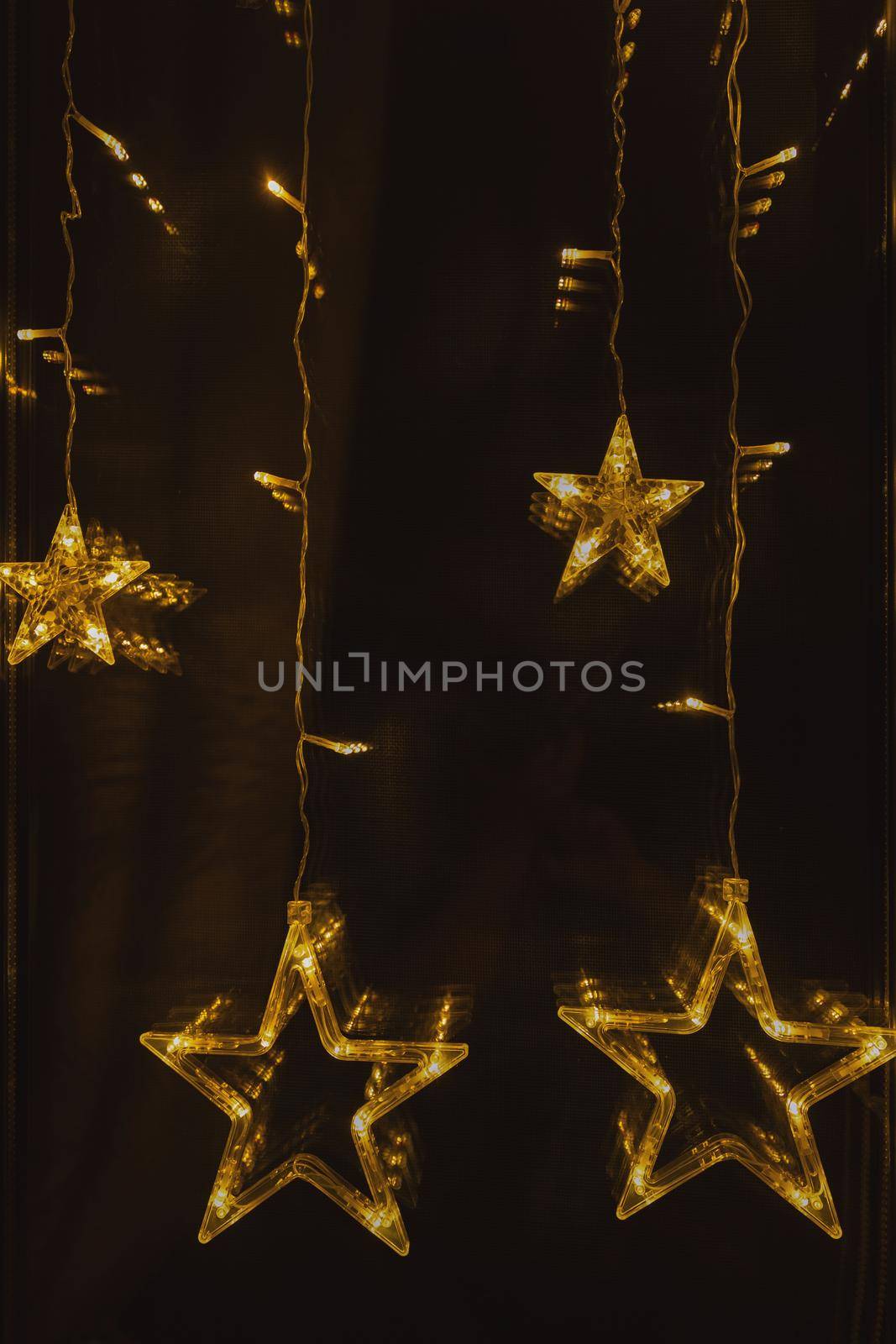 christmas glowing garland in the form of stars on the window