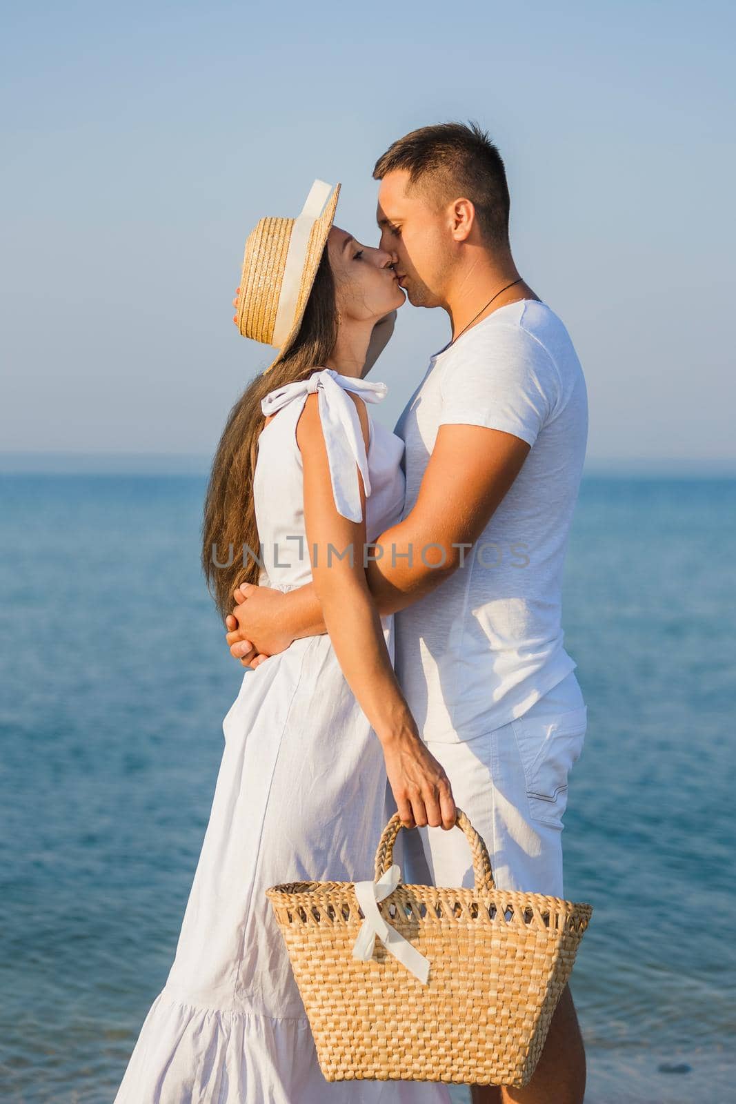 couple kissing on the background of the sea by zokov