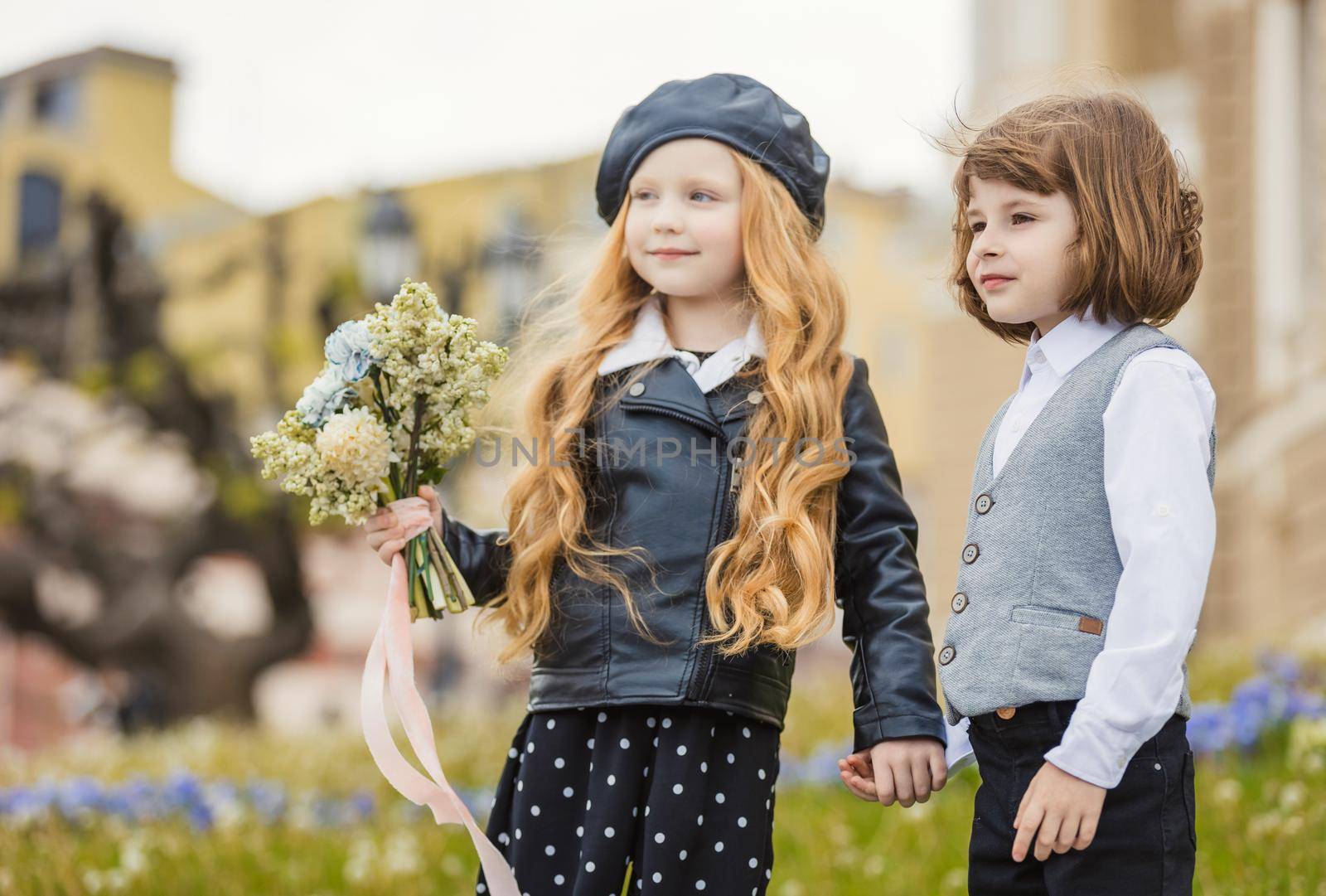 a couple of children standing on the lawn portraying themselves as adults