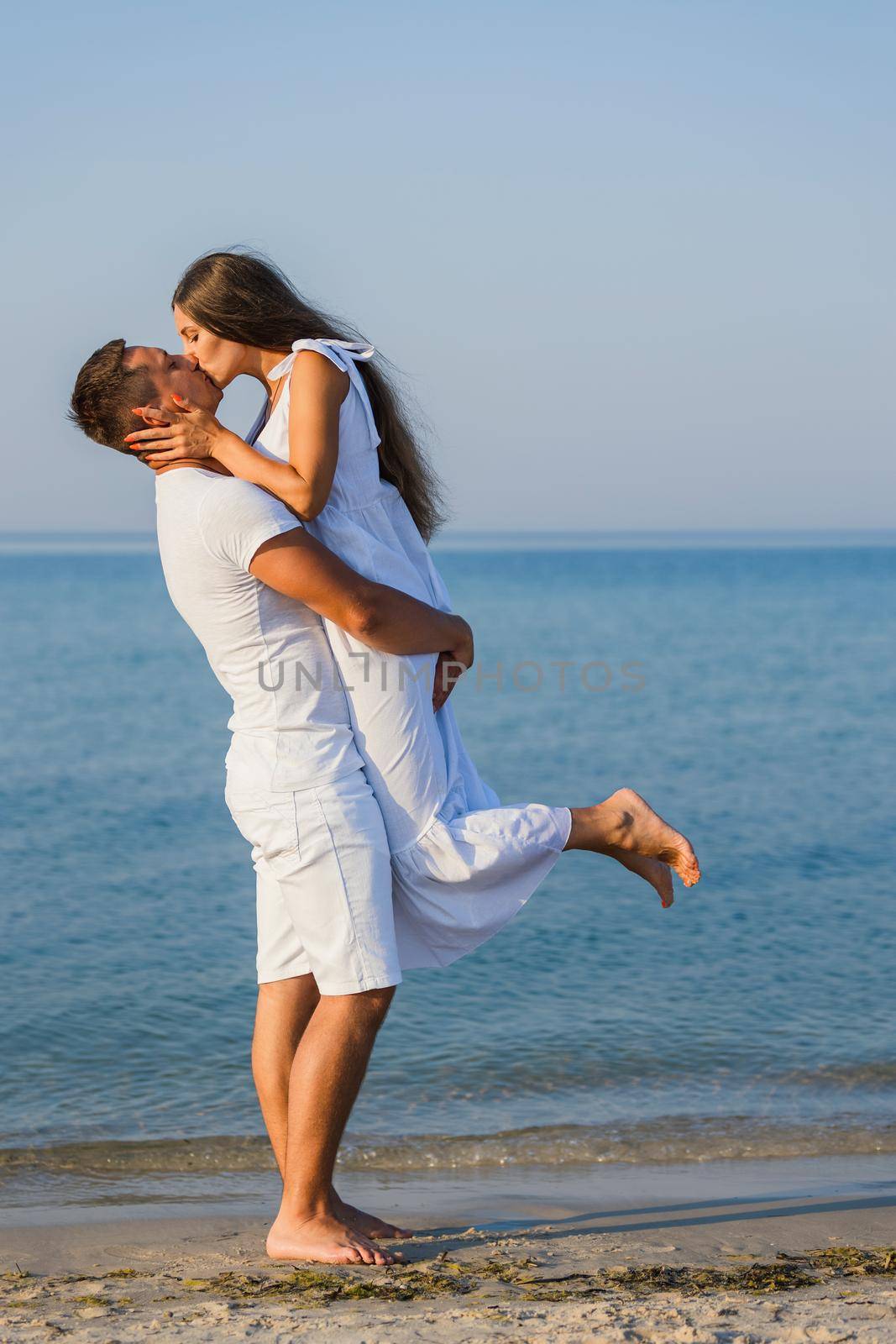 couple kissing on the background of the sea by zokov