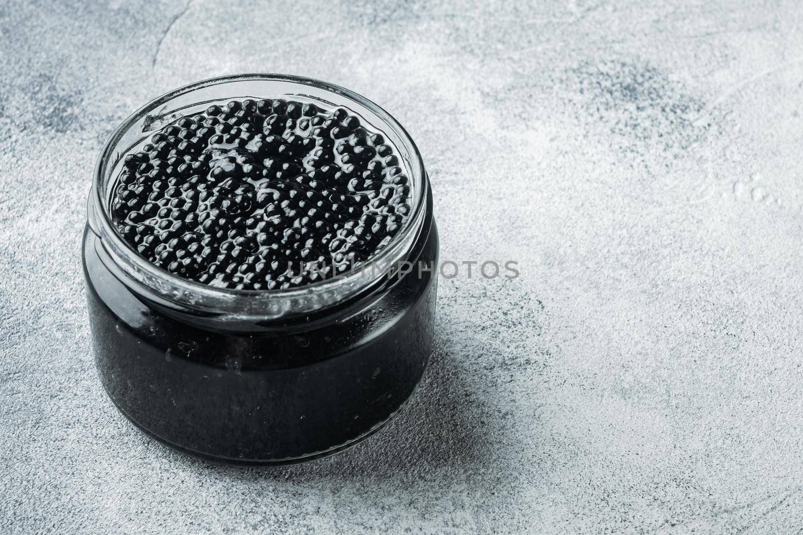 Black sturgeon caviar, on gray background with copy space for text by Ilianesolenyi