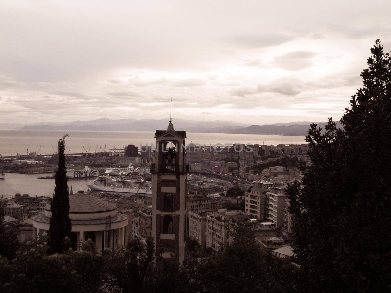 ROME, ITALY - February 05, 2022: Panoramic view around the Colosseum in city of Rome, Italy. Cold and gray sky in the background. Macro photography of the green parks with the old buildings.