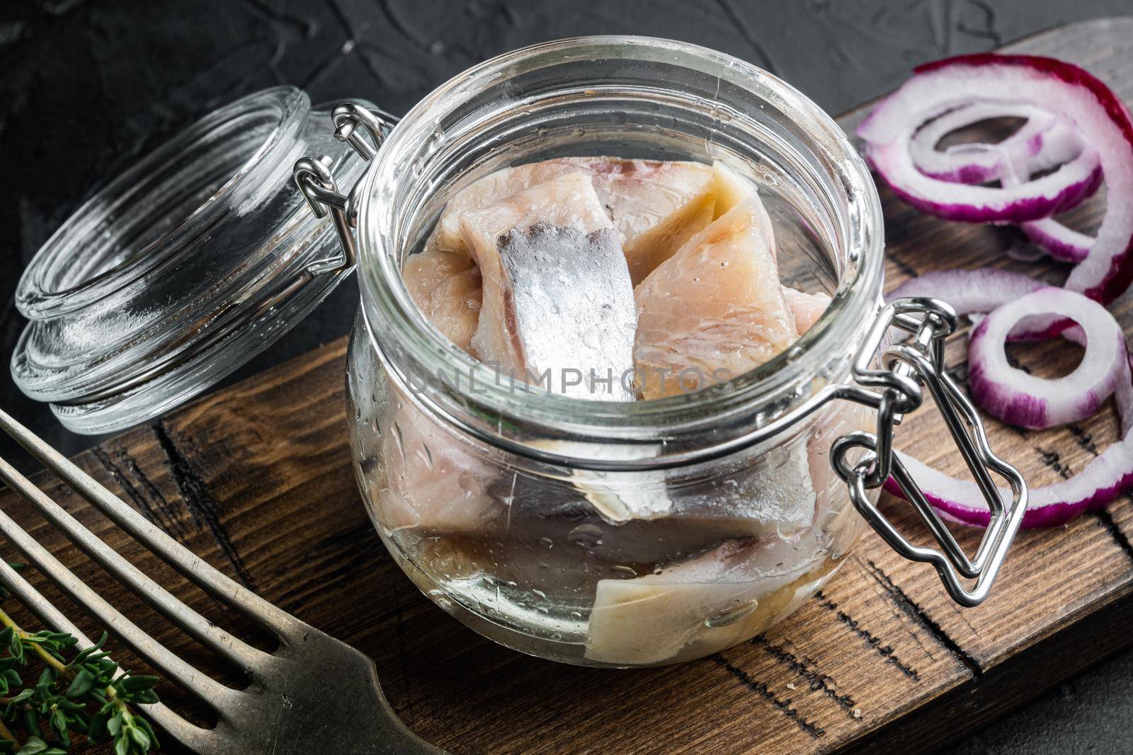 Pickled herring, on black background by Ilianesolenyi