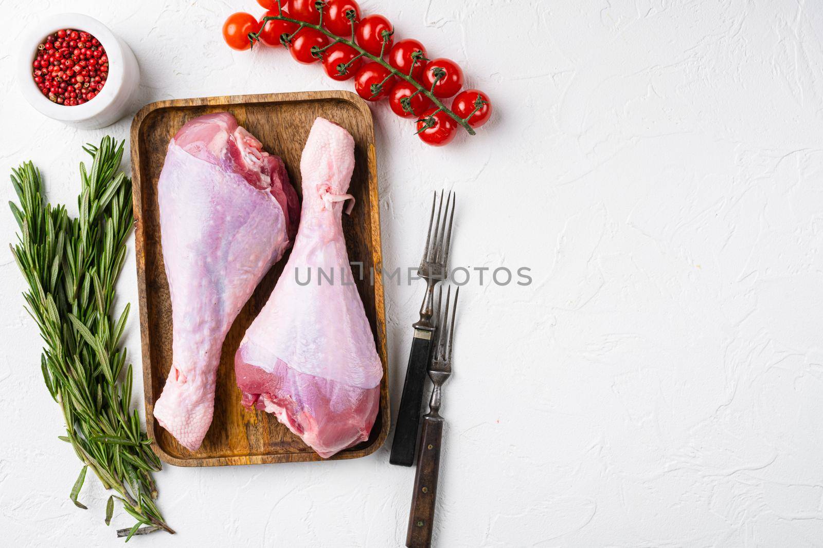 Turkey raw meat leg set, on white stone table background, top view flat lay, with copy space for text by Ilianesolenyi