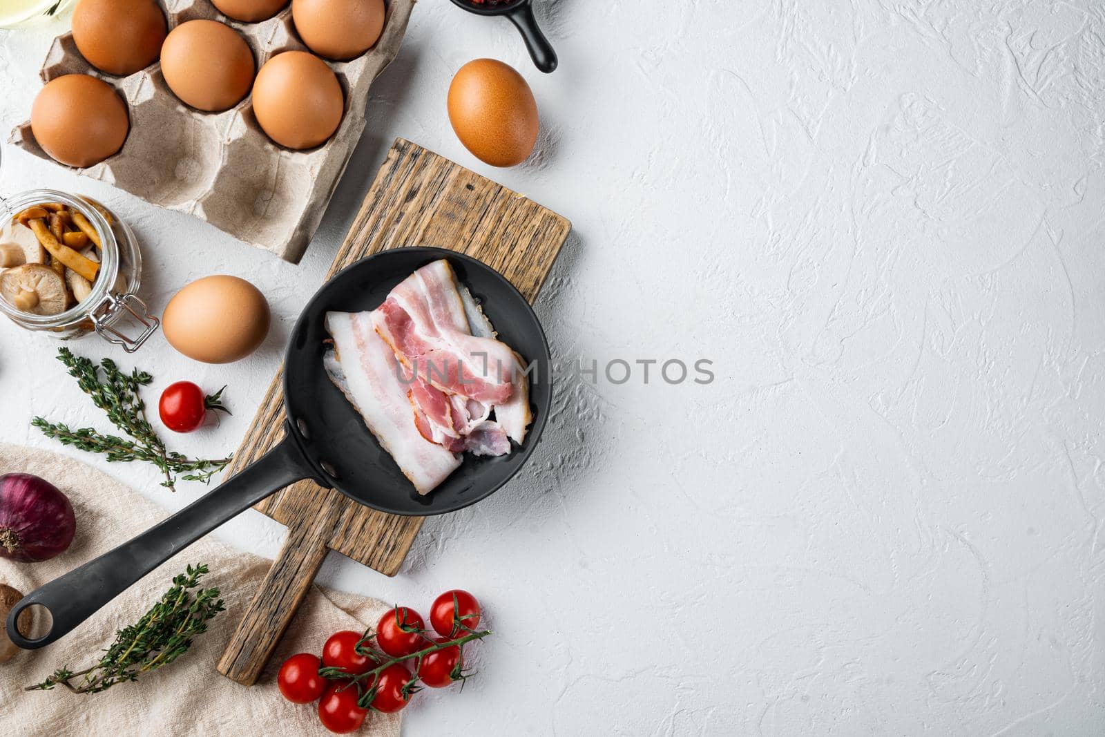 Healthy breakfast ingredients for fried eggs, on white background, top view flat lay , with space for text copyspace by Ilianesolenyi