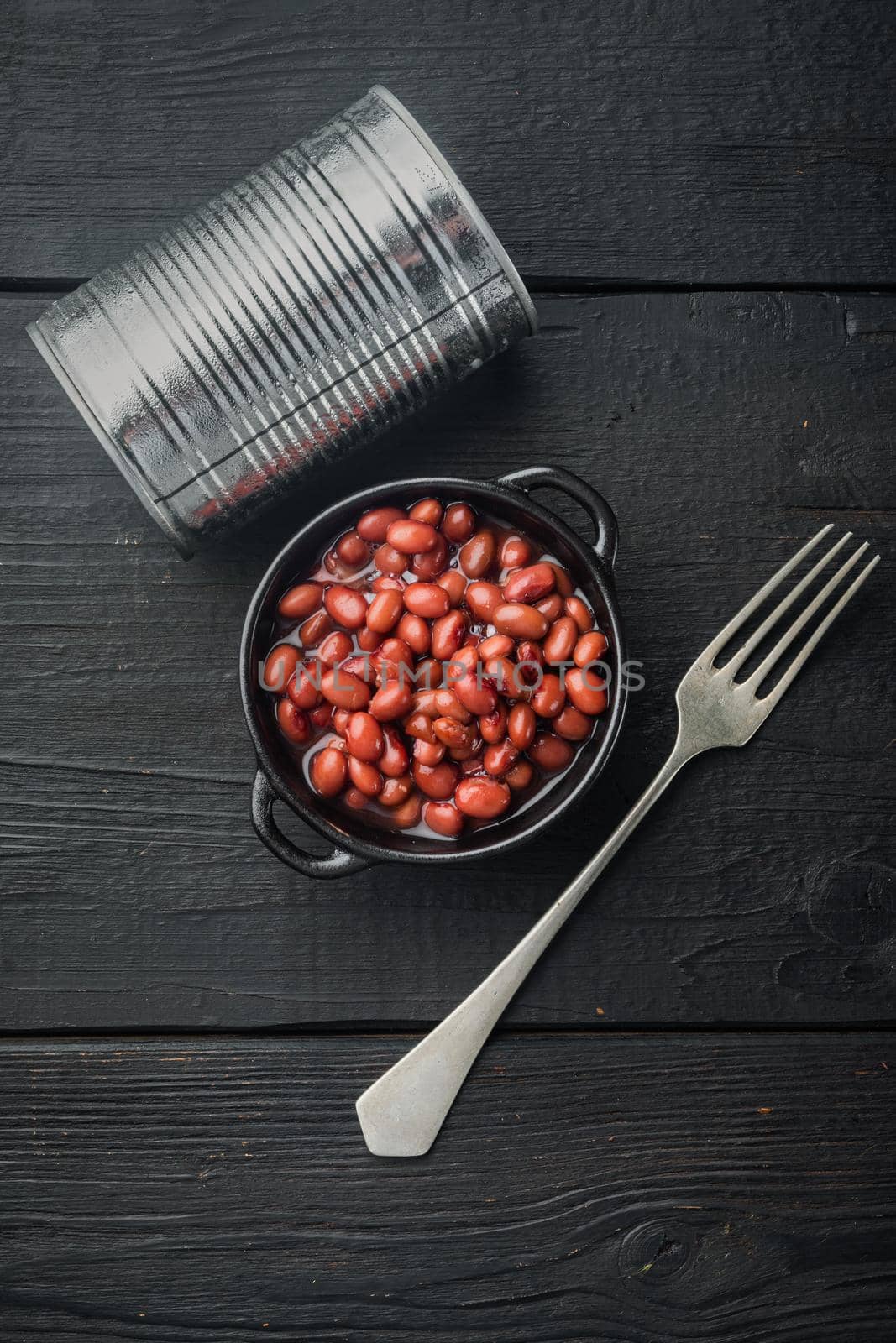 Azuki red beans, on black wooden table background, top view flat lay