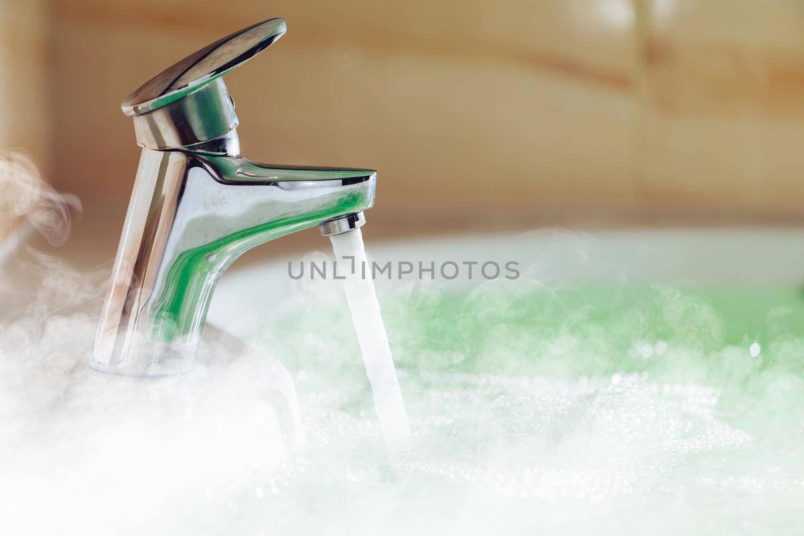 water tap pouring hot water in a bath tub with steam by nikkytok