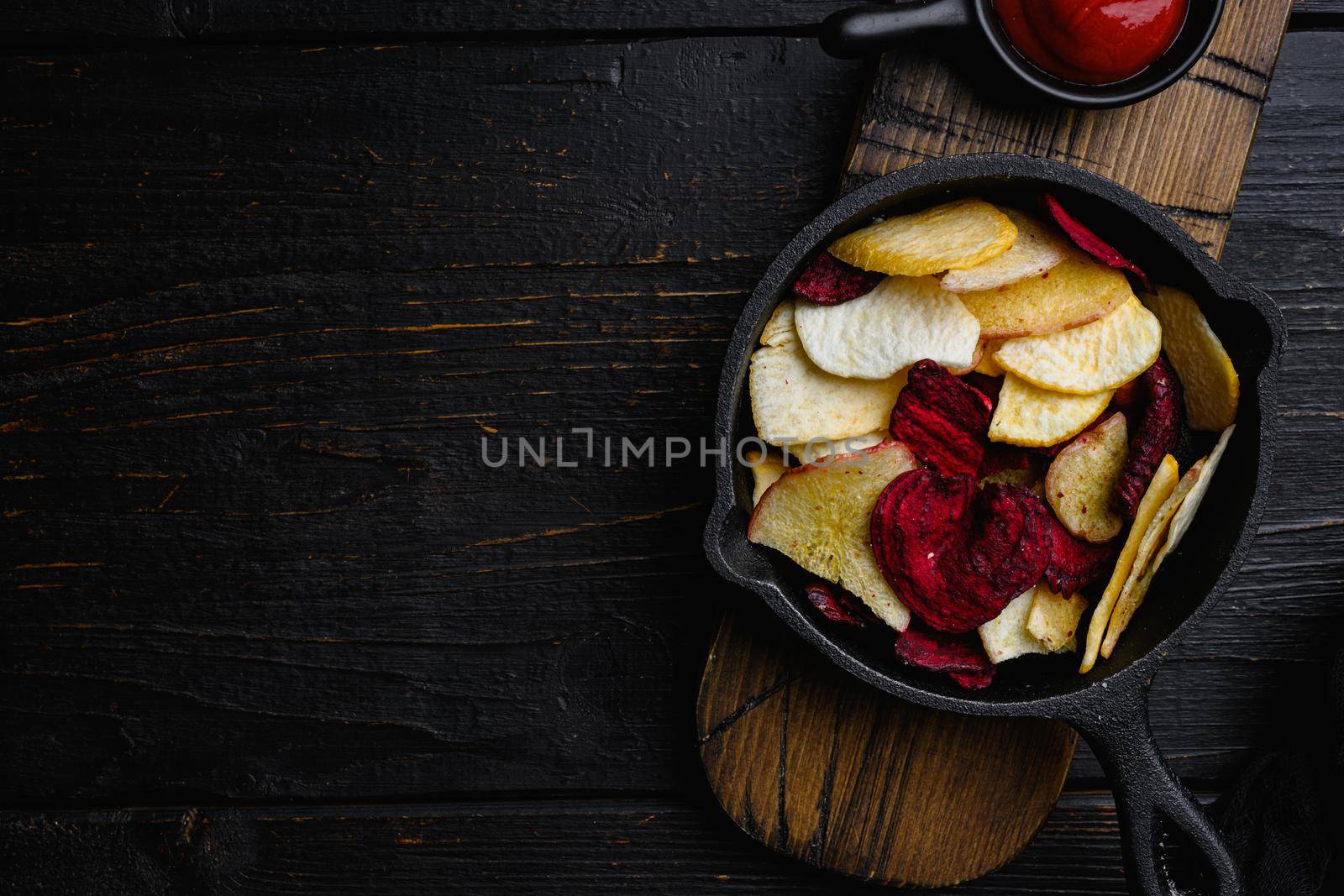 Beetroot carrot and turnip chips set, on black wooden table background, top view flat lay, with copy space for text