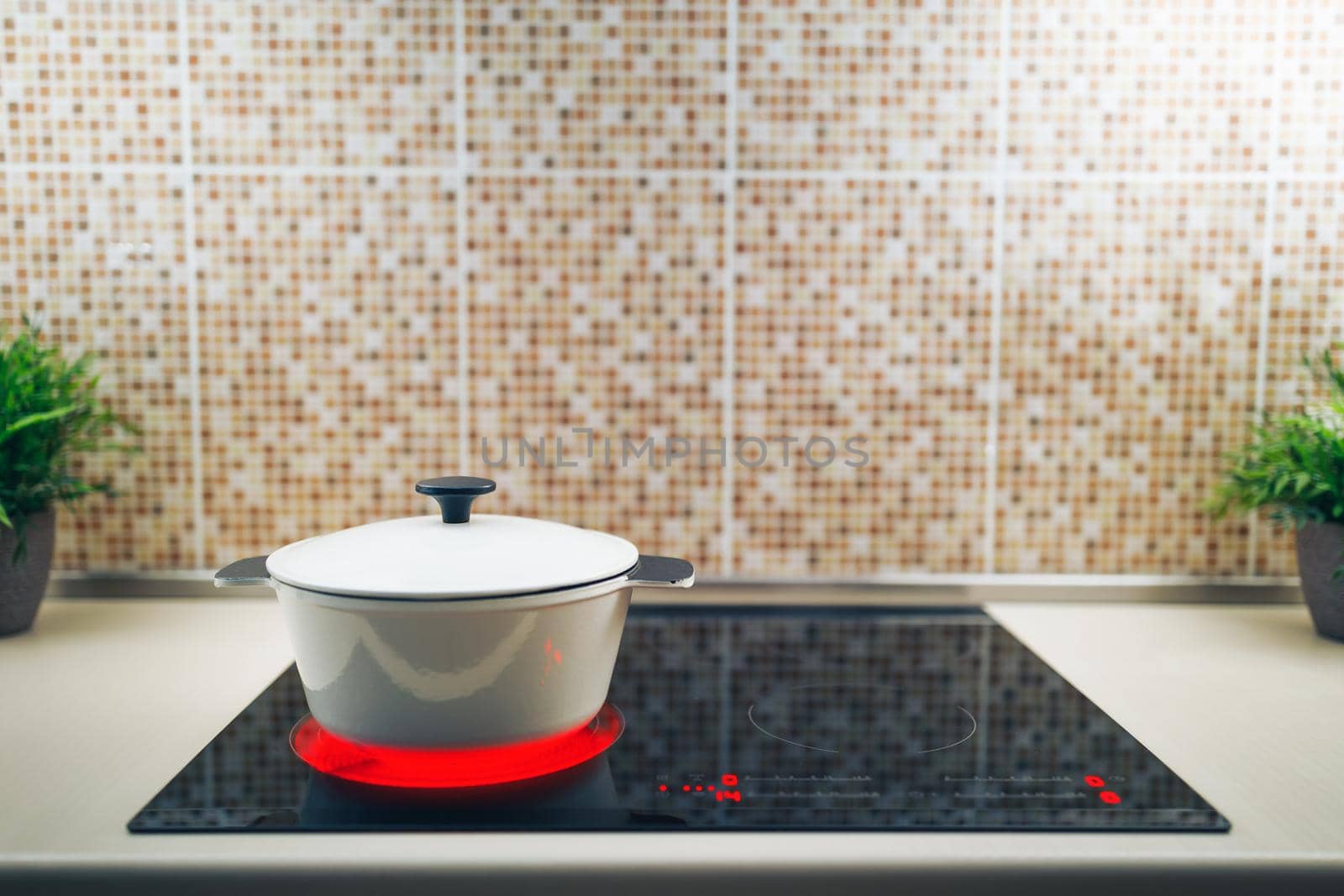 white pot on electrical induction cooktop by nikkytok