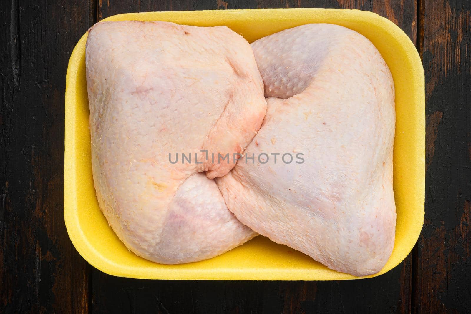 Fresh Chicken Whole Legs set, in Foam Tray Pack, on old dark wooden table, top view flat lay