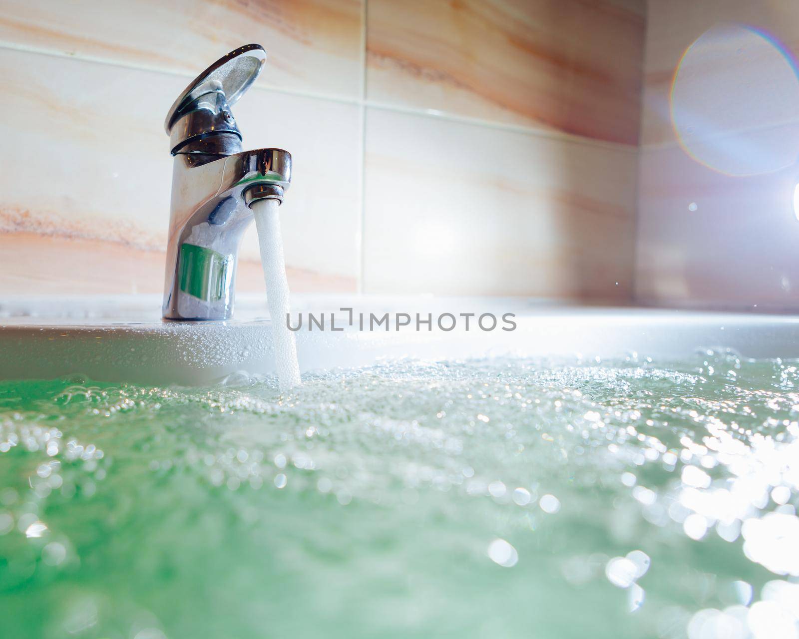 single handle faucet pouring hot water in a bath tub