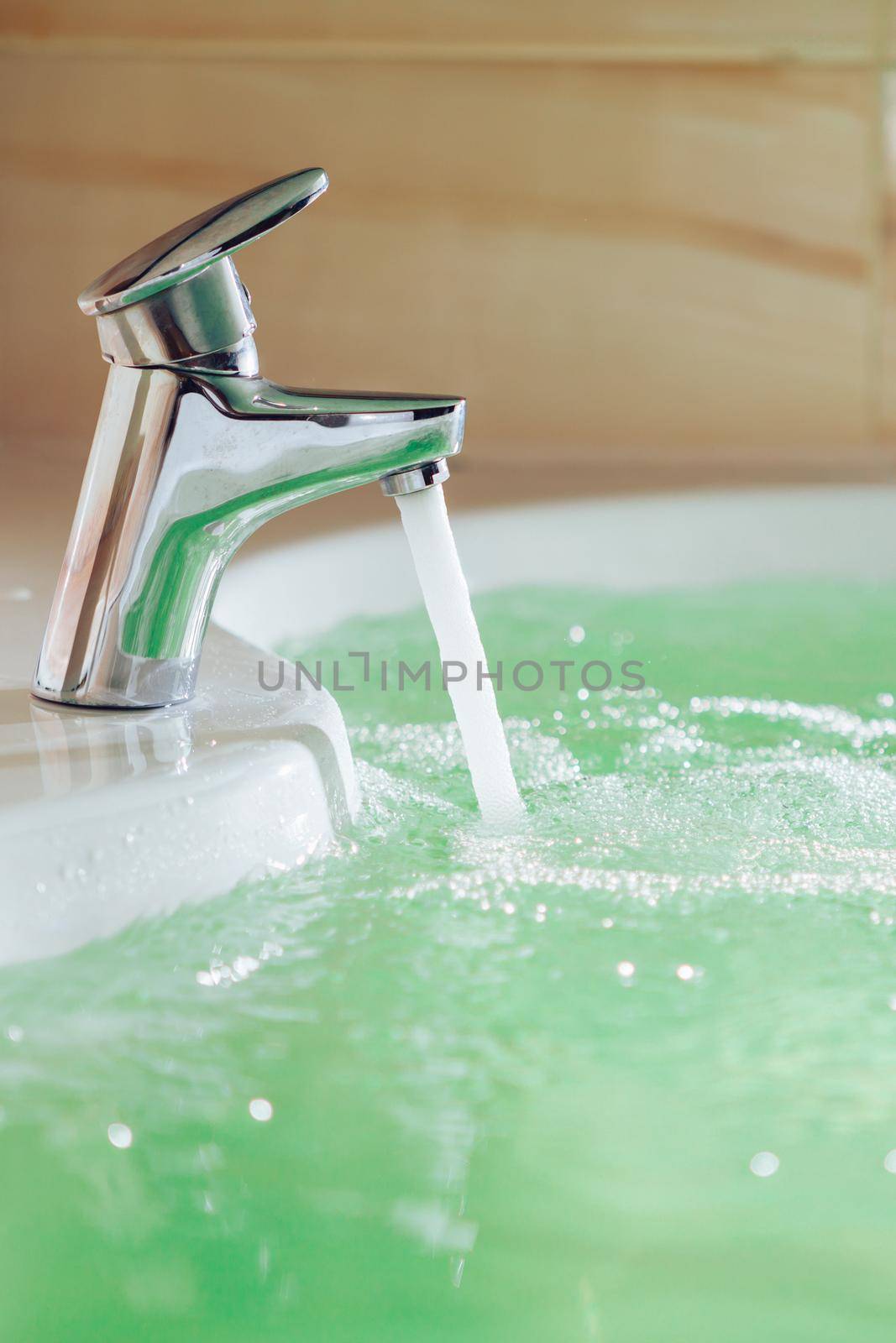 single handle faucet pouring hot water in a bath tub