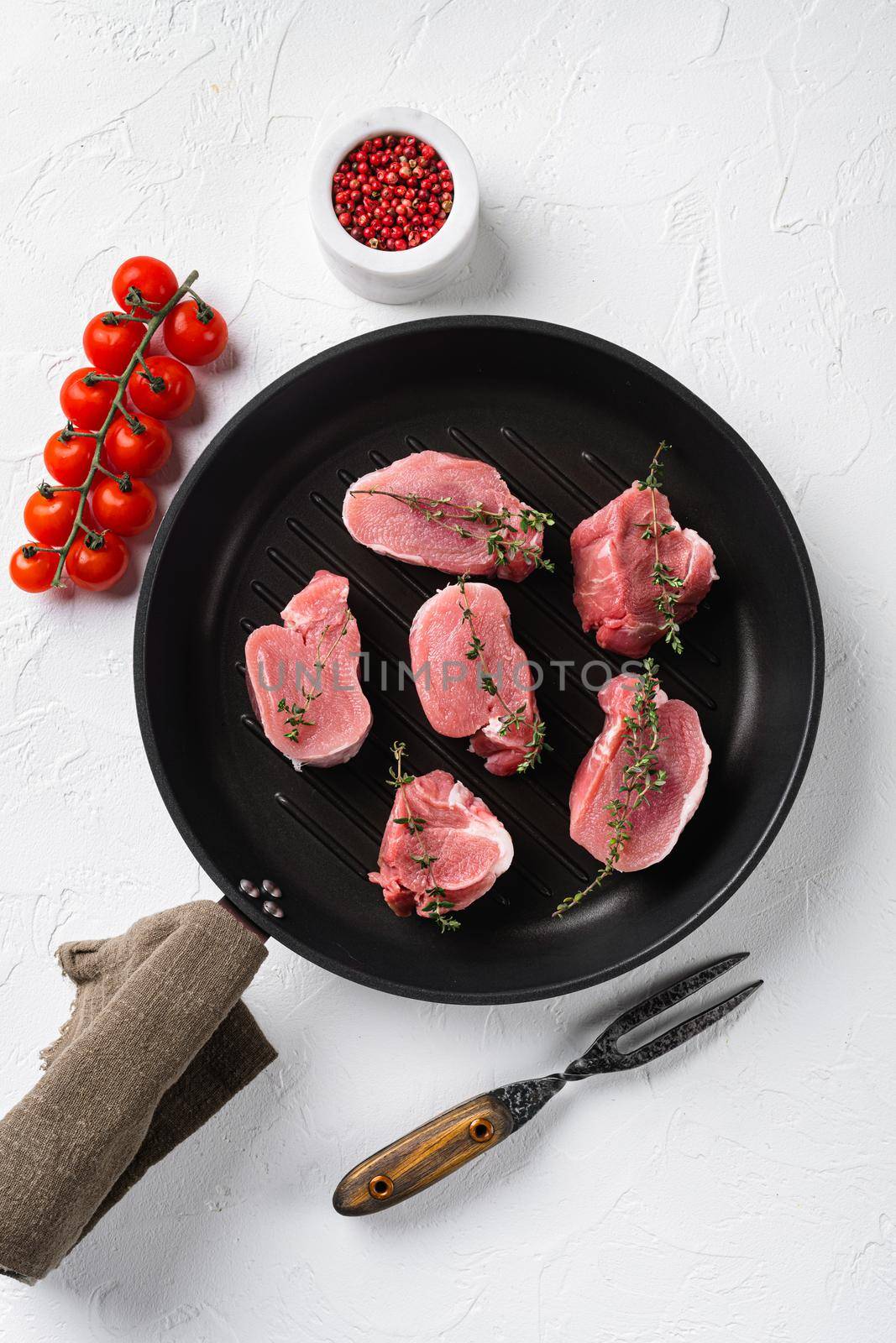 Pork tenderloin. Fresh raw meat prepared for cooking set, on white stone table background, top view flat lay by Ilianesolenyi