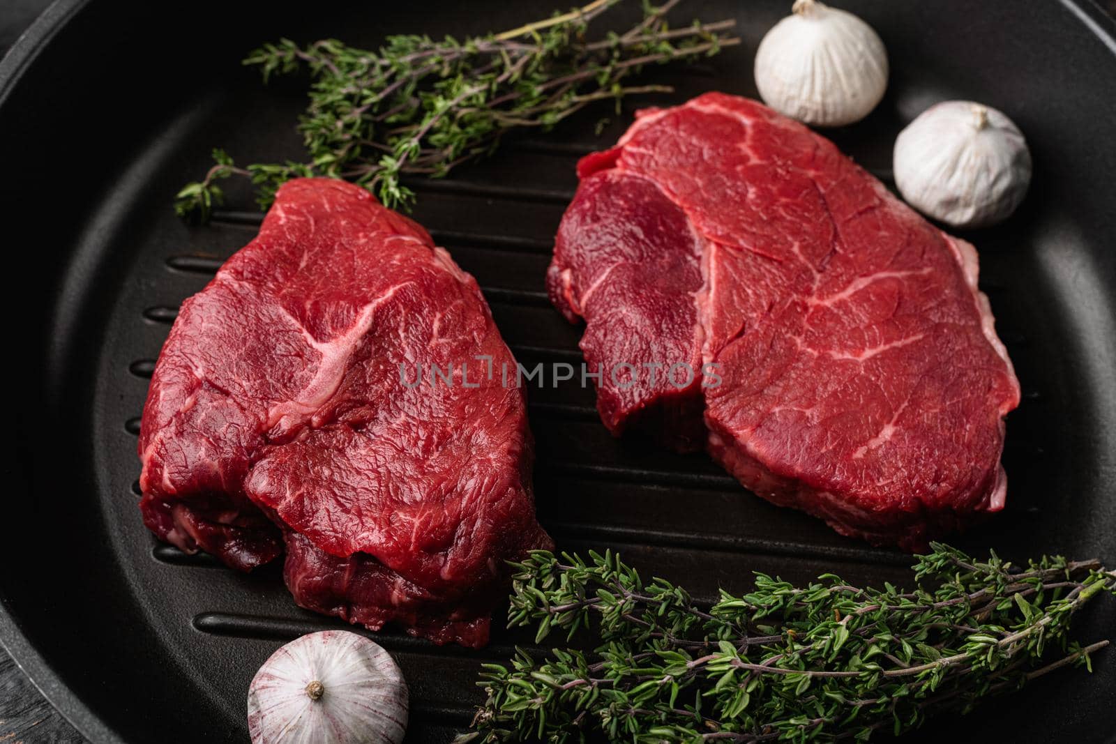 Uncooked Raw rump steak beef meat, on black wooden table background by Ilianesolenyi