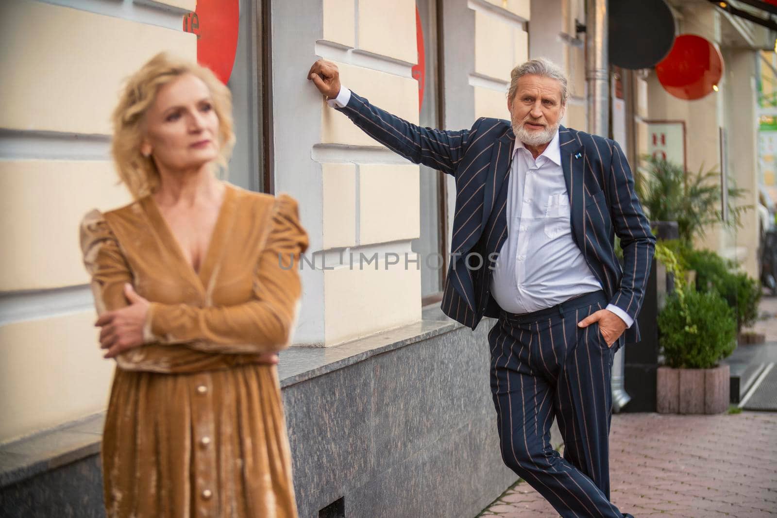 aged couple walking in the city center