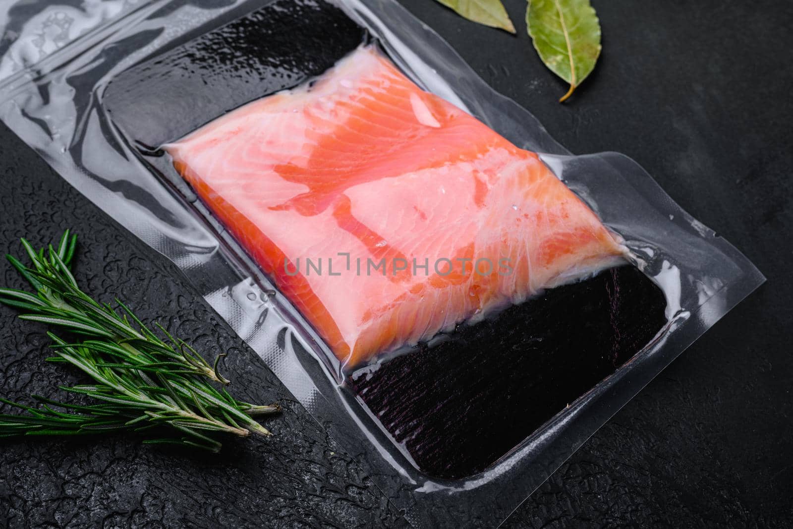 Fresh salmon fillet cut set, on black dark stone table background by Ilianesolenyi
