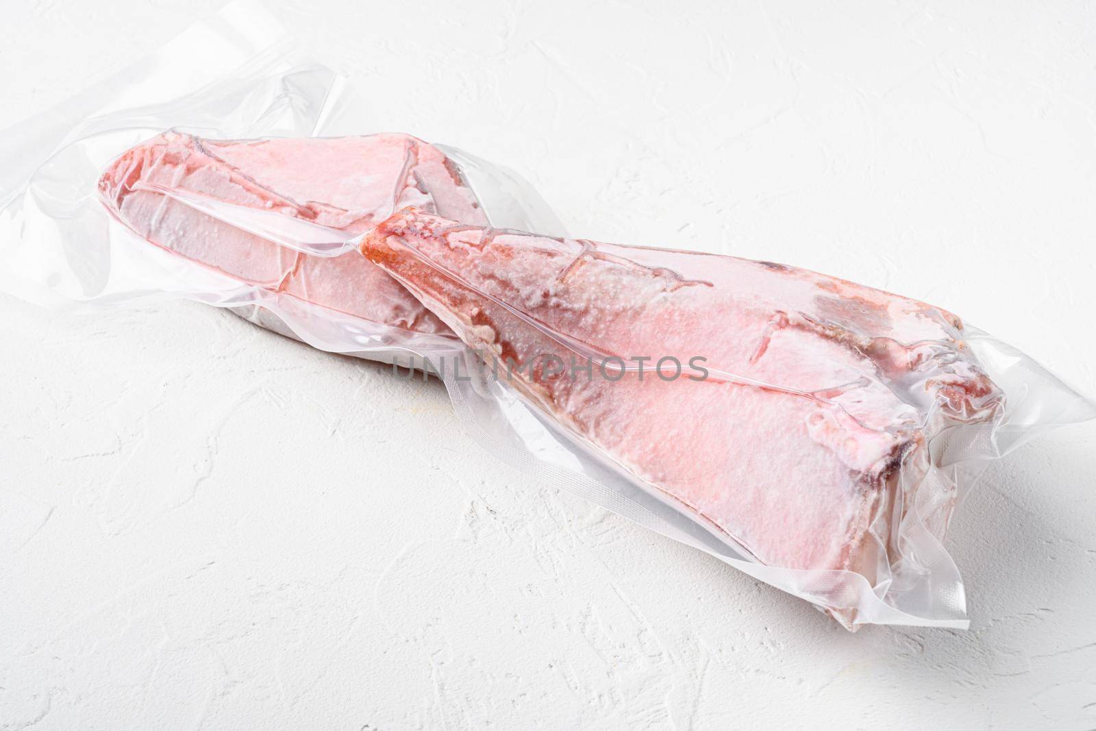 Sea bass frozen pack fish meat set, on white stone table background, with copy space for text