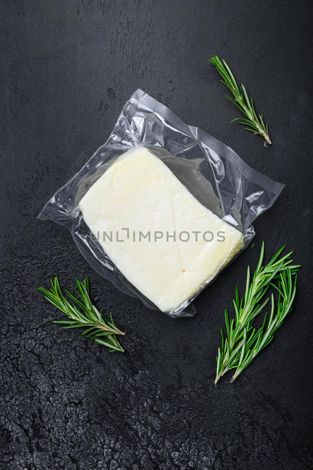 Fresh halloumi cheese set, on black dark stone table background, top view flat lay, with copy space for text by Ilianesolenyi