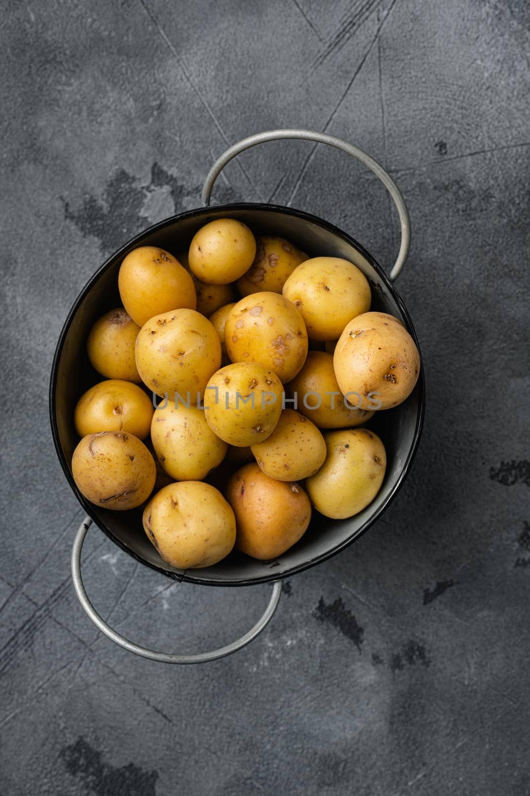 Baby potato, on gray stone table background, top view flat lay, with copy space for text