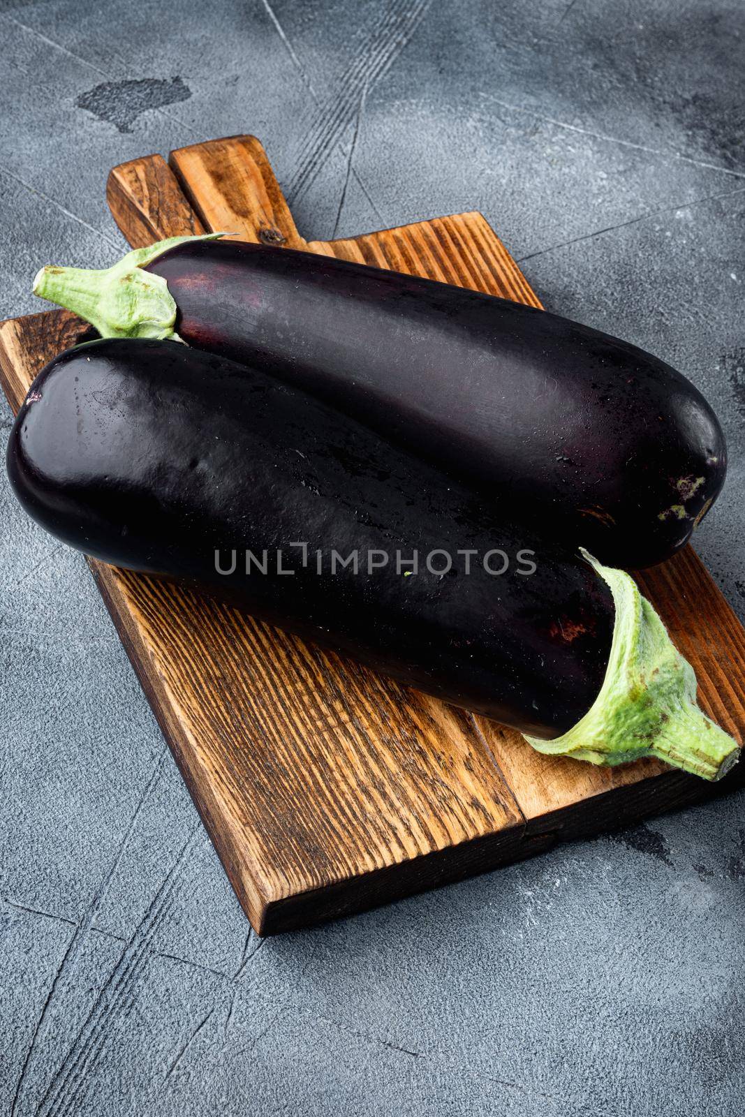 Eggplant, aubergine organic ripe whole vegetables, on gray stone background by Ilianesolenyi