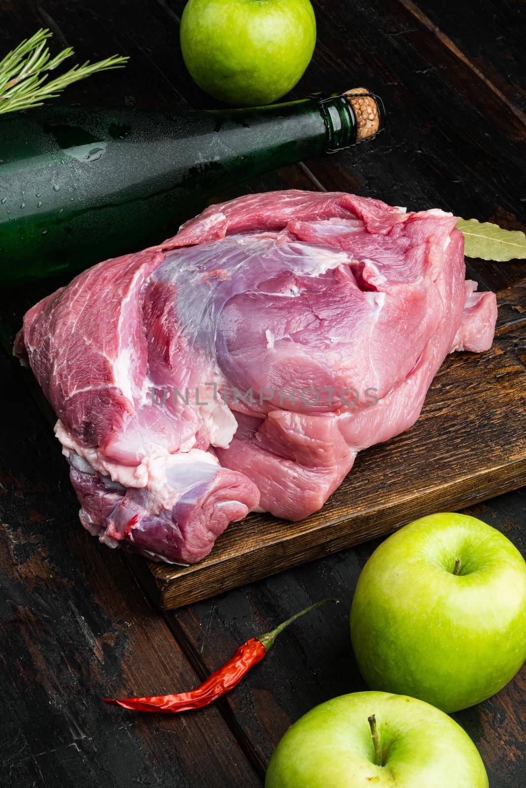 Ingredients for Roasted pork loin, with apple dry cider, on old dark wooden table background by Ilianesolenyi