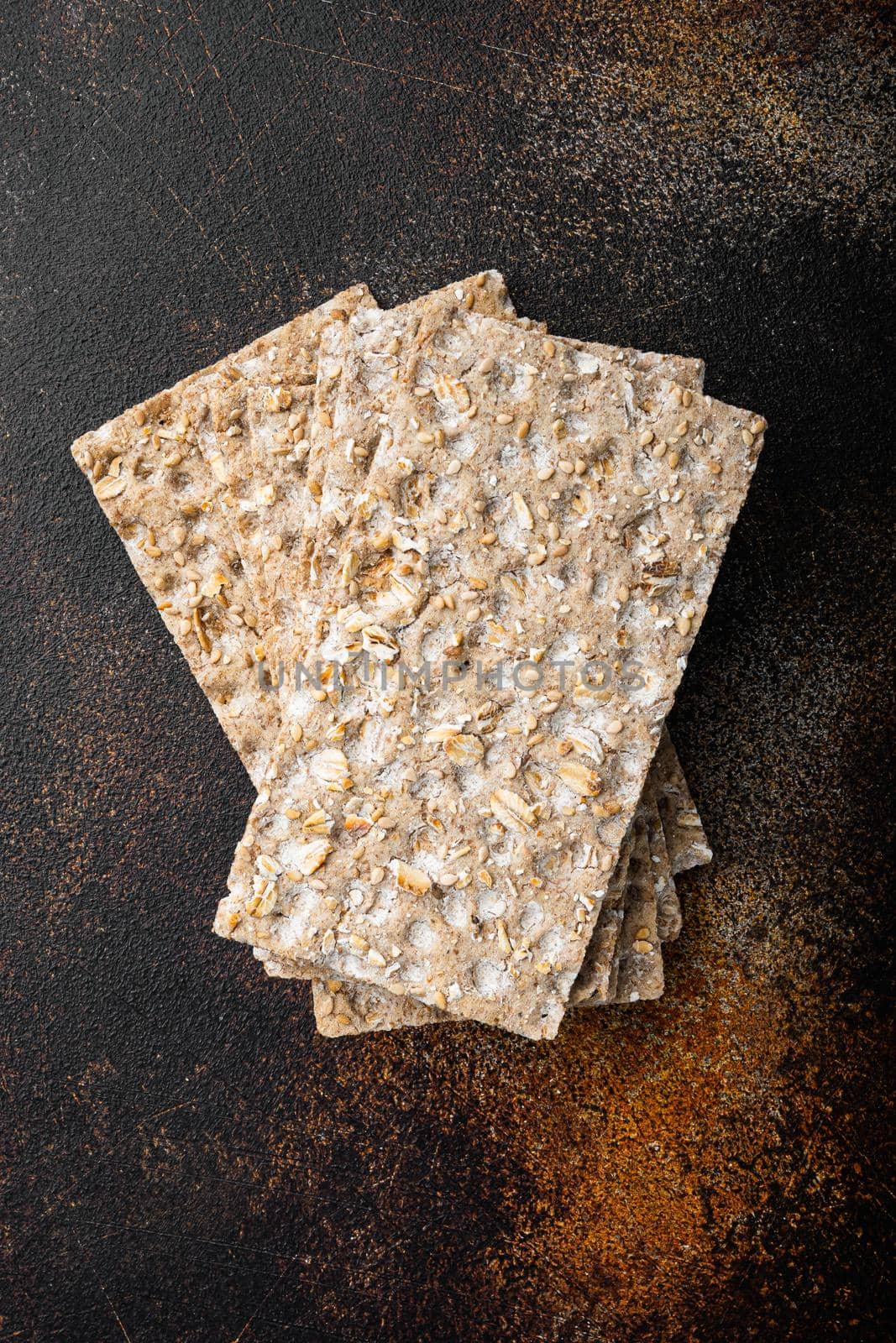 Thin rye crispy cracker set, on old dark rustic table background, top view flat lay