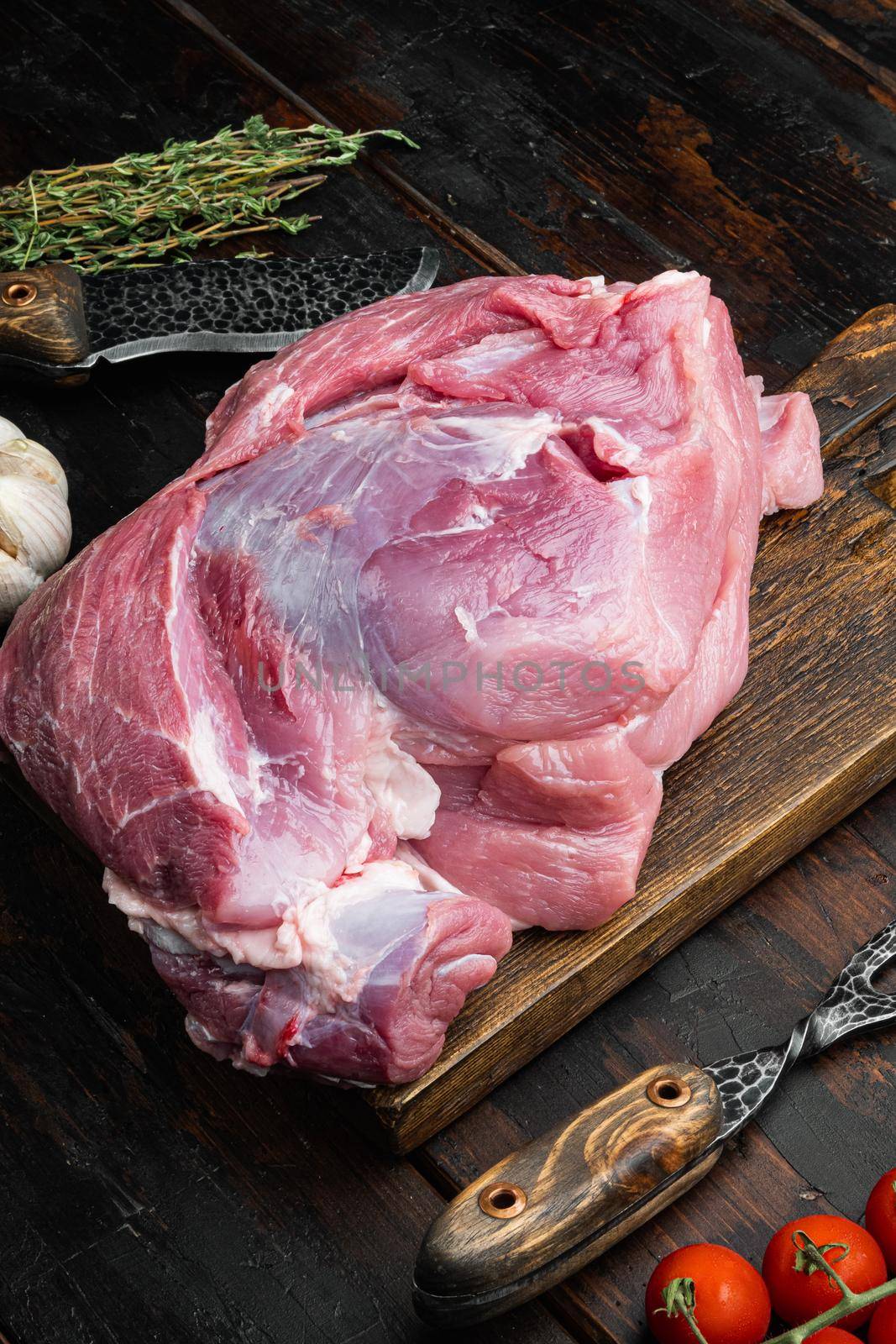 Raw pork meat with herbs set, on old dark wooden table background