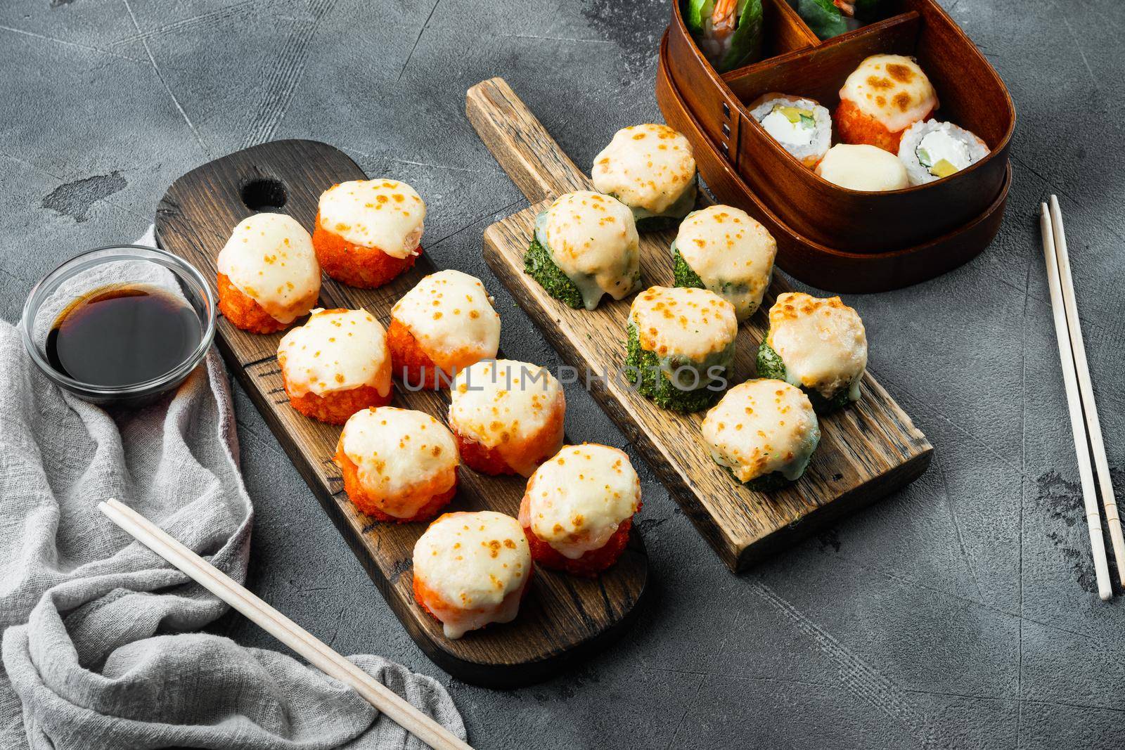 Japanese sushi rolls named Baked Ebi with wasabi and salmon fish set, on gray stone background