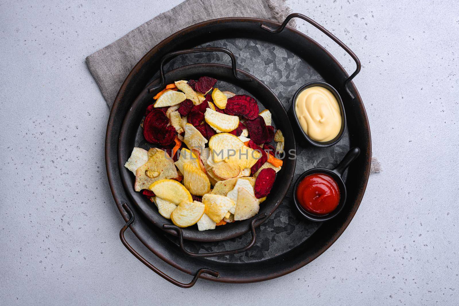 Root Vegetable Crisps, on gray stone table background, top view flat lay, with copy space for text by Ilianesolenyi