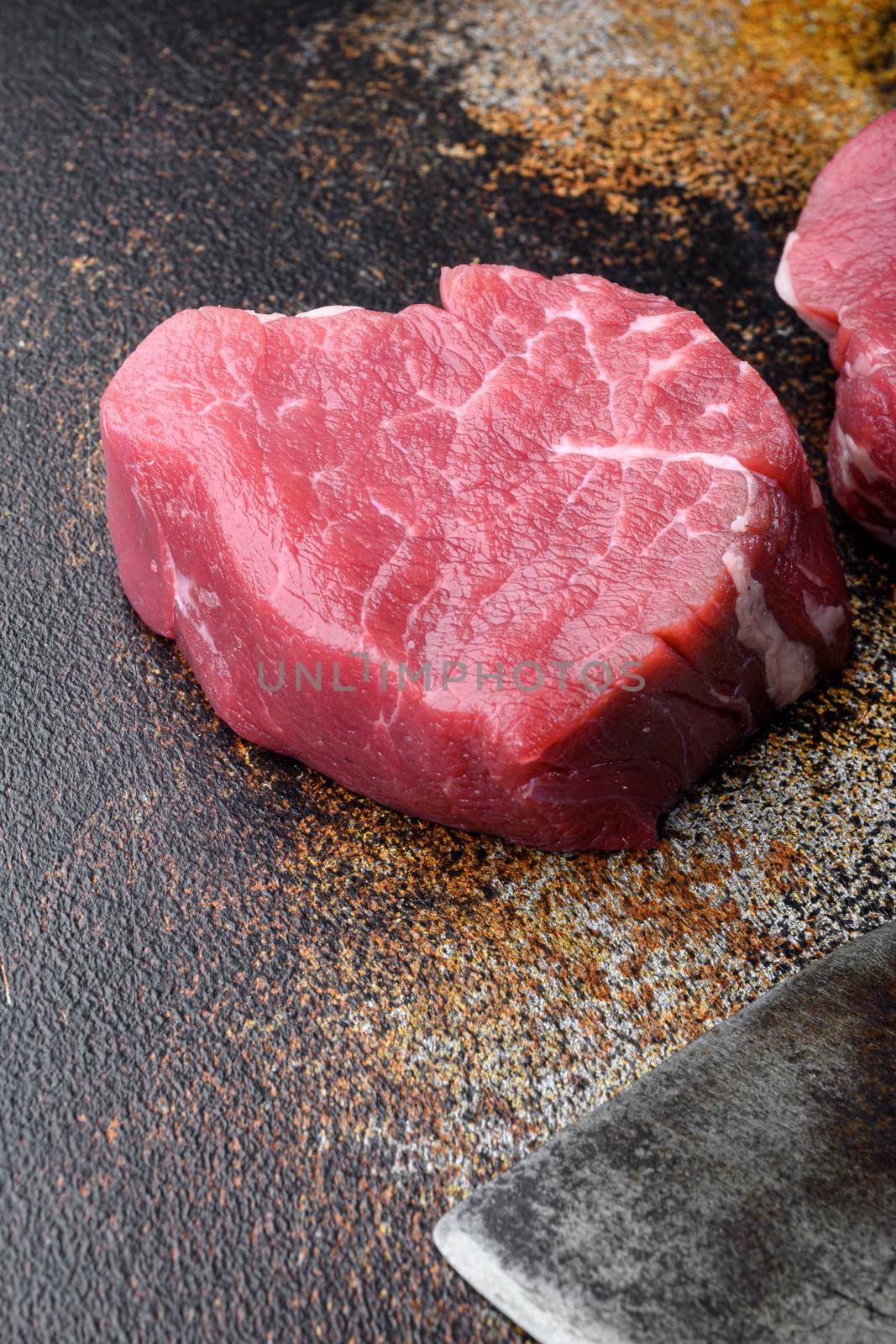 Fillet mignon steak raw, on old dark rustic background by Ilianesolenyi