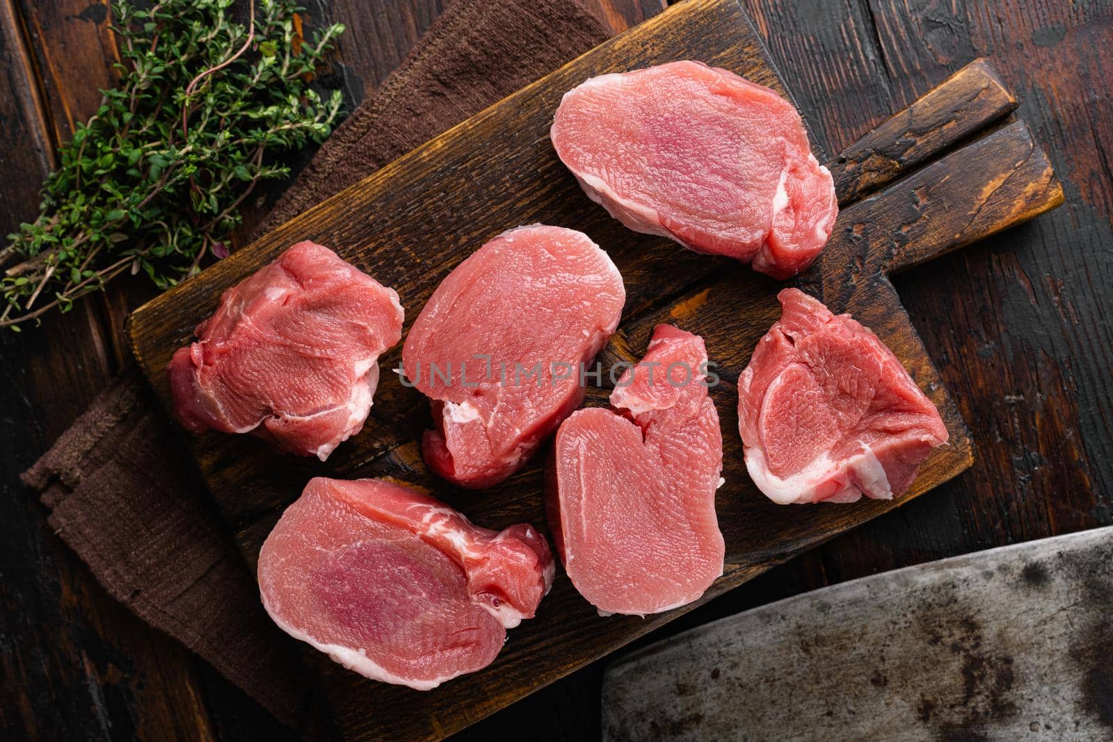 Organic pork meat chops set, on old dark wooden table background, top view flat lay by Ilianesolenyi