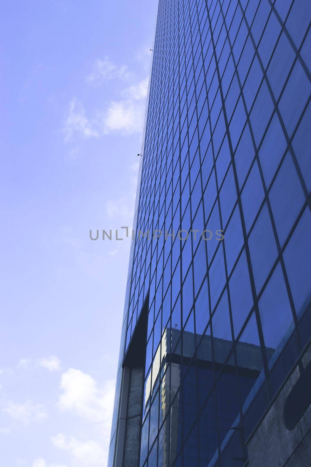 Genova, Italy-January 29, 2022: Beautiful modern high-rise buildings against the sky. 3d illustration on the theme of business success and technology. clouds reflection on the mirror.Industrial zone.