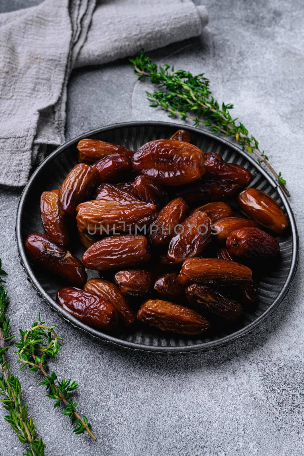 Traditional arabic dry dates set, on gray stone table background by Ilianesolenyi