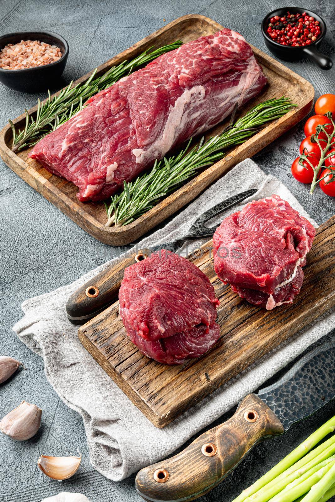 Raw fresh marbled meat Black Angus set, Filet mignon tenderloin cut, on wooden cutting board, on gray stone background