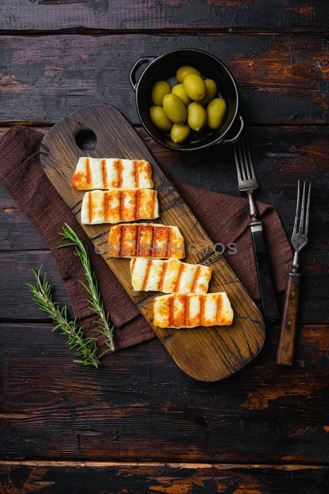 Traditinal Cypriot Halloumi Cheese, on old dark wooden table background, top view flat lay by Ilianesolenyi