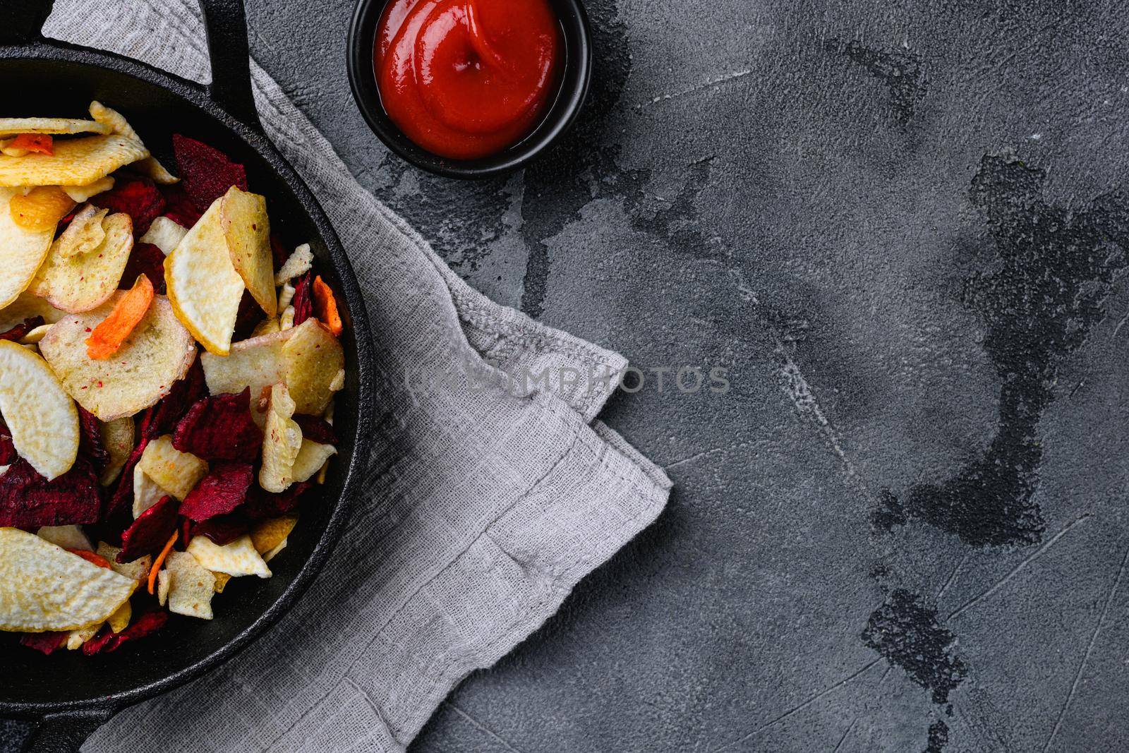 Dried vegetables chips set, on gray stone table background, top view flat lay, with copy space for text
