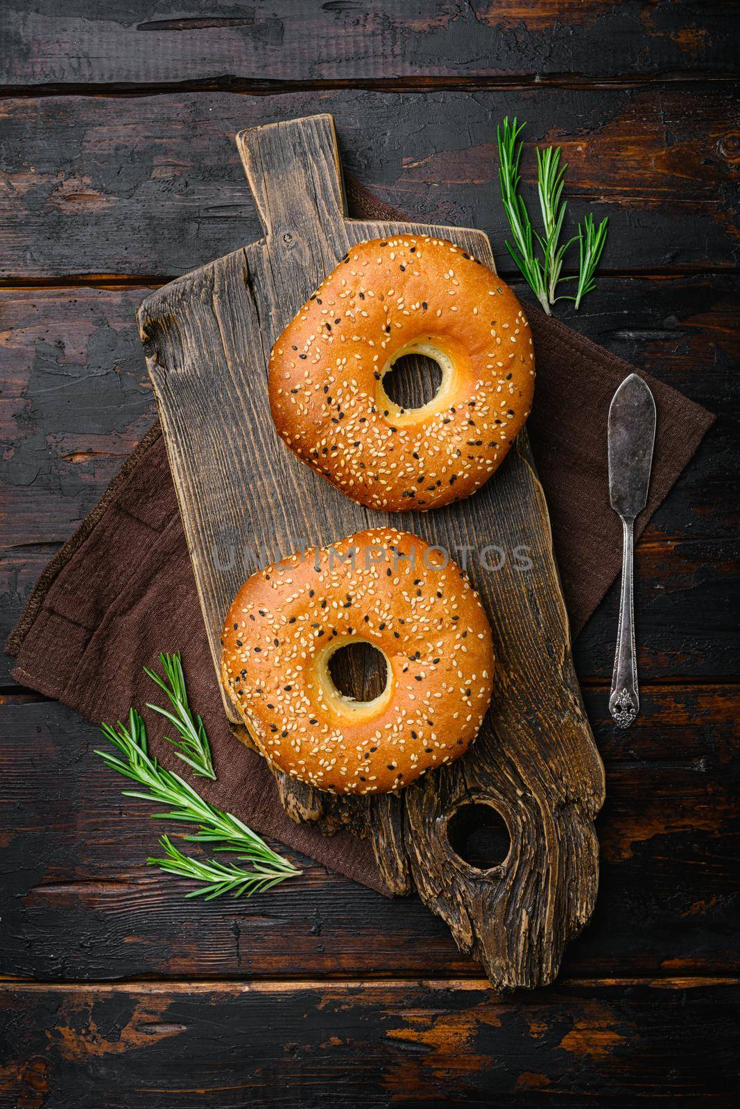Bagel Freshly Baked set, on old dark wooden table background, top view flat lay by Ilianesolenyi