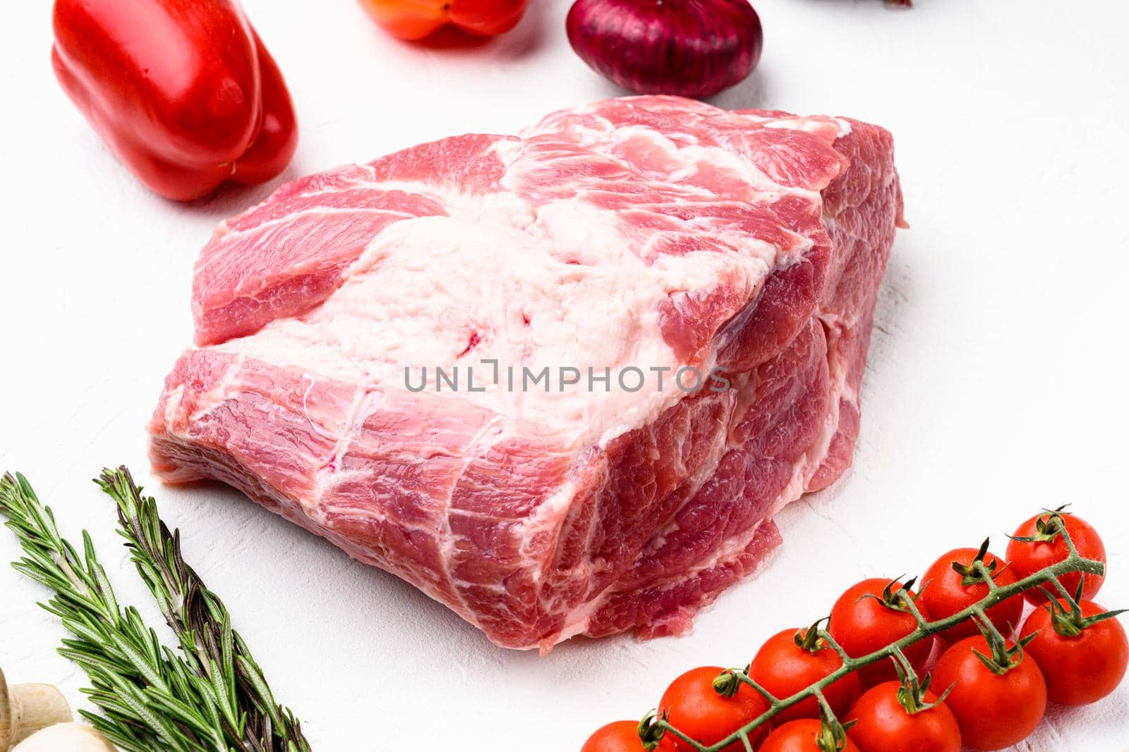 Pork Neck meat steak, with ingredients and herbs, on white stone table background by Ilianesolenyi