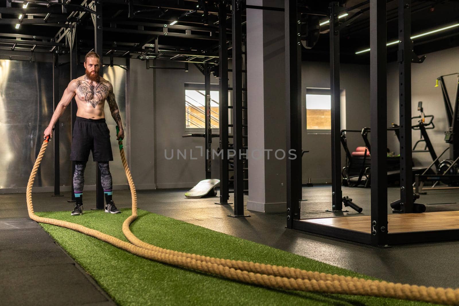 Rope man grass warehouse green fitness training gym exercising exercise, for athlete one from male from healthy moving, sport muscle. Standing ground holding, lifestyles