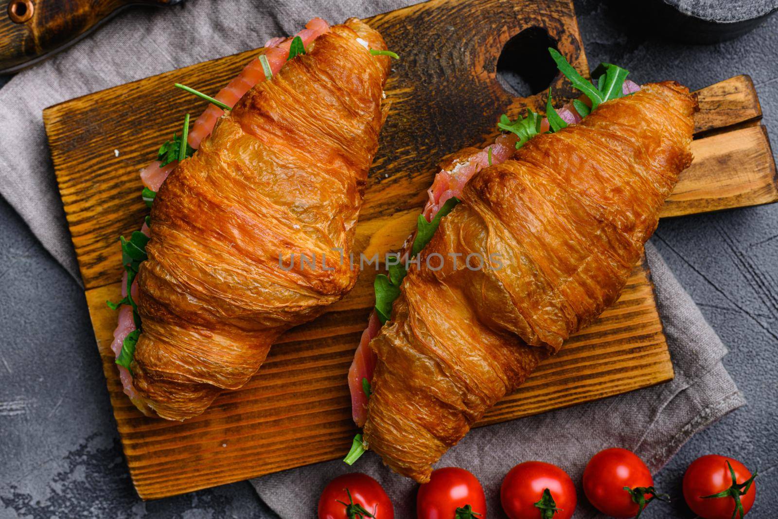 Croissant with salmon and cream cheese set, on gray stone table background, top view flat lay