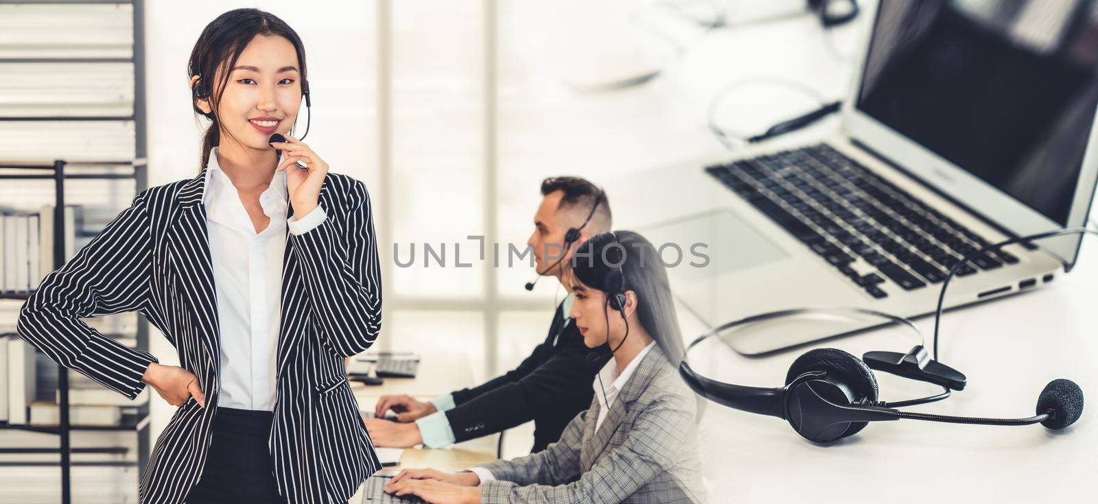 Business people wearing headset working in office broaden view by biancoblue