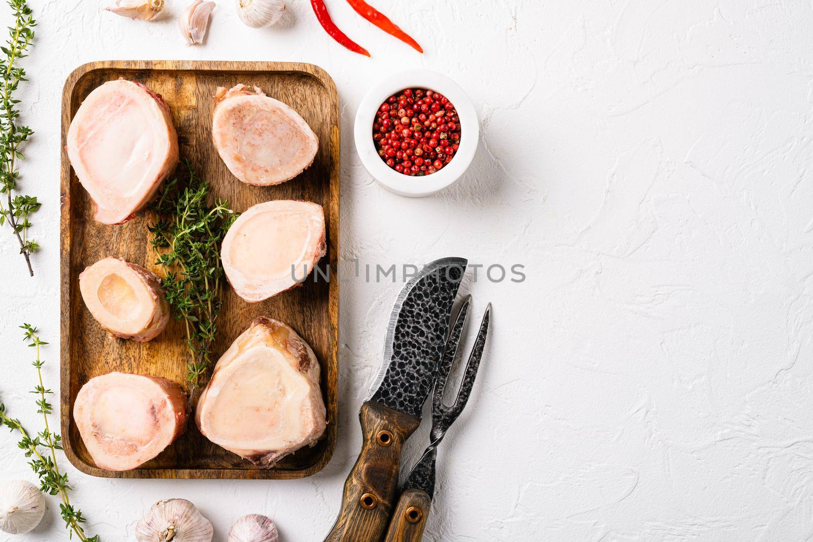 Ingredients for preparing beef broth, on white stone table background, top view flat lay, with copy space for text by Ilianesolenyi