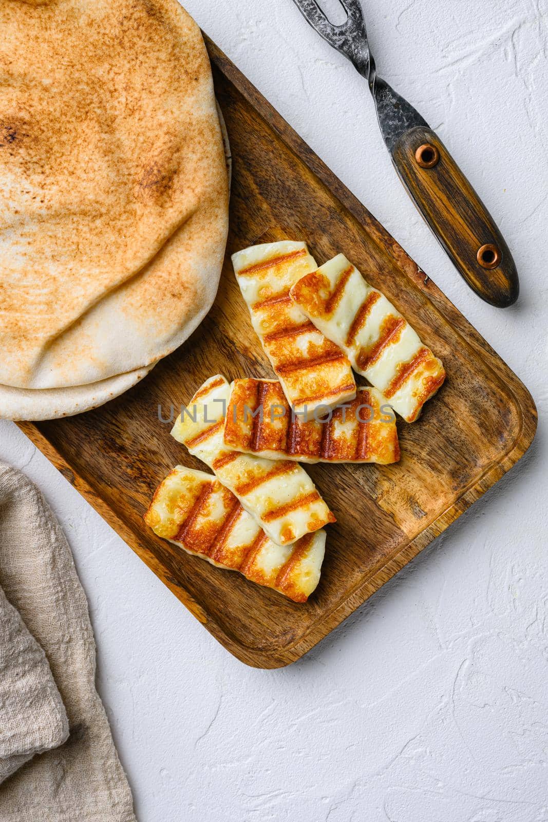 Grilled Halloumi, fried cheese, on white stone table background, top view flat lay by Ilianesolenyi