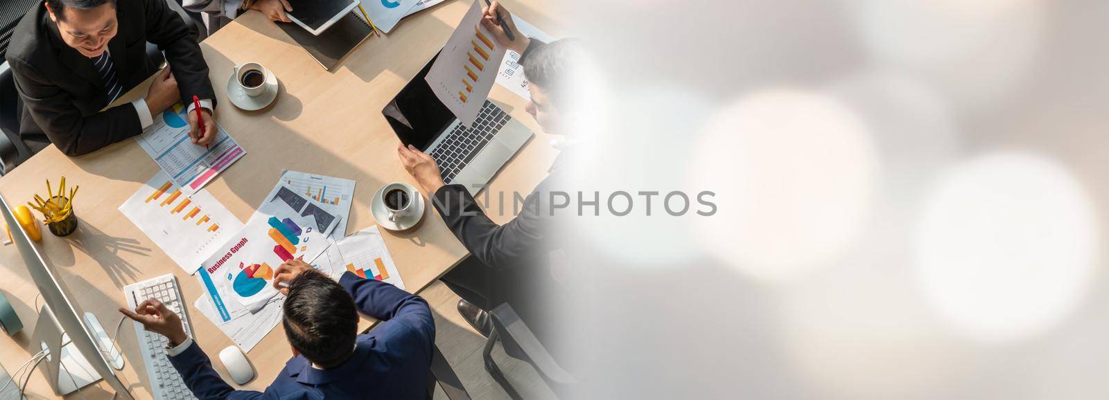 Business people group meeting shot from top widen view in office . Profession businesswomen, businessmen and office workers working in team conference with project planning document on meeting table .