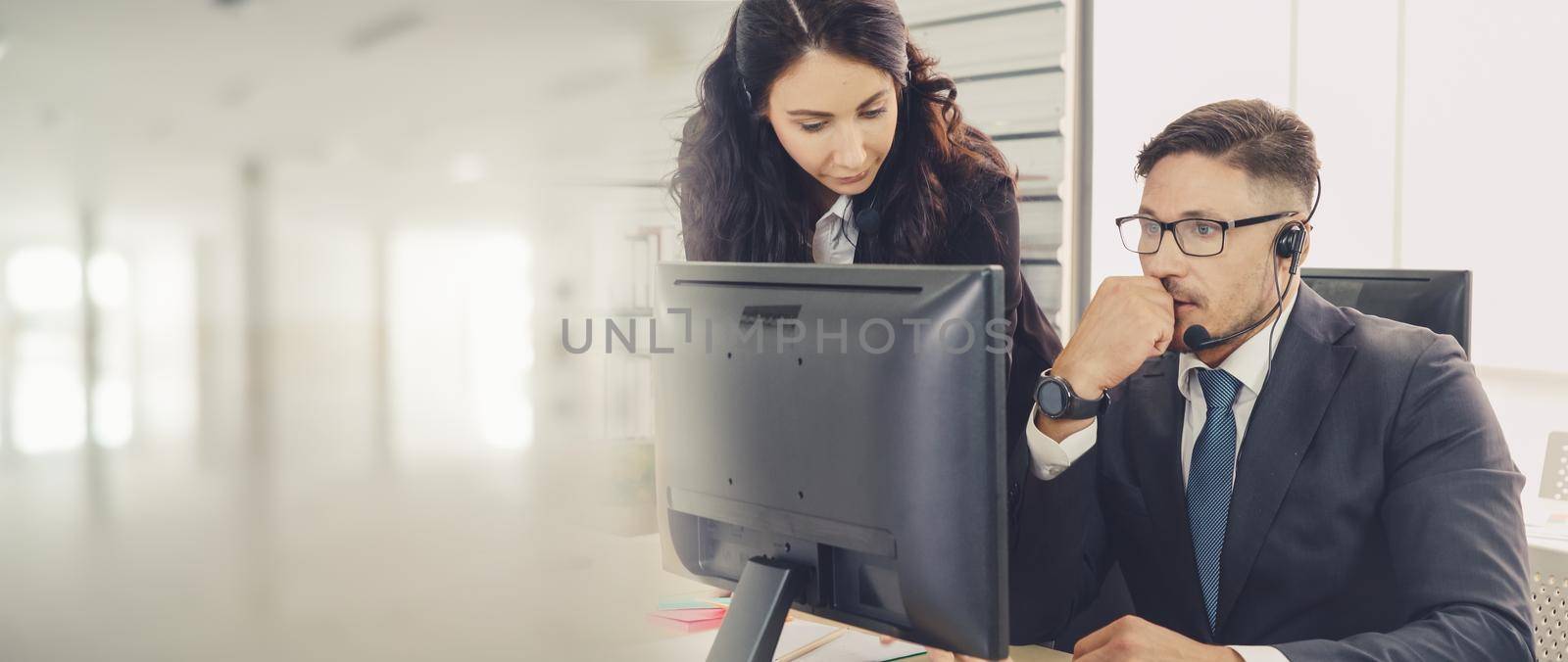 Business people wearing headset working in office broaden view by biancoblue