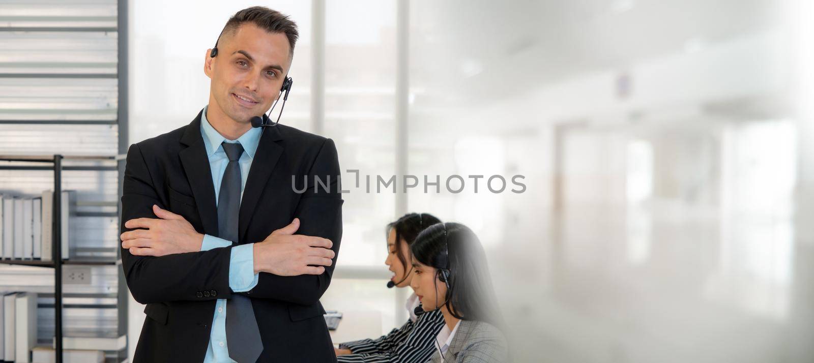 Business people wearing headset working in office broaden view by biancoblue